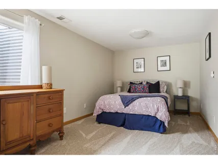 a spacious bedroom with a bed and a window