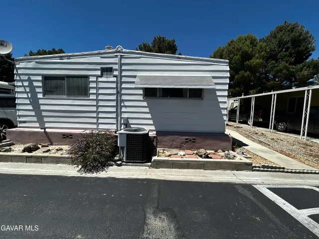 a view of building with car parked