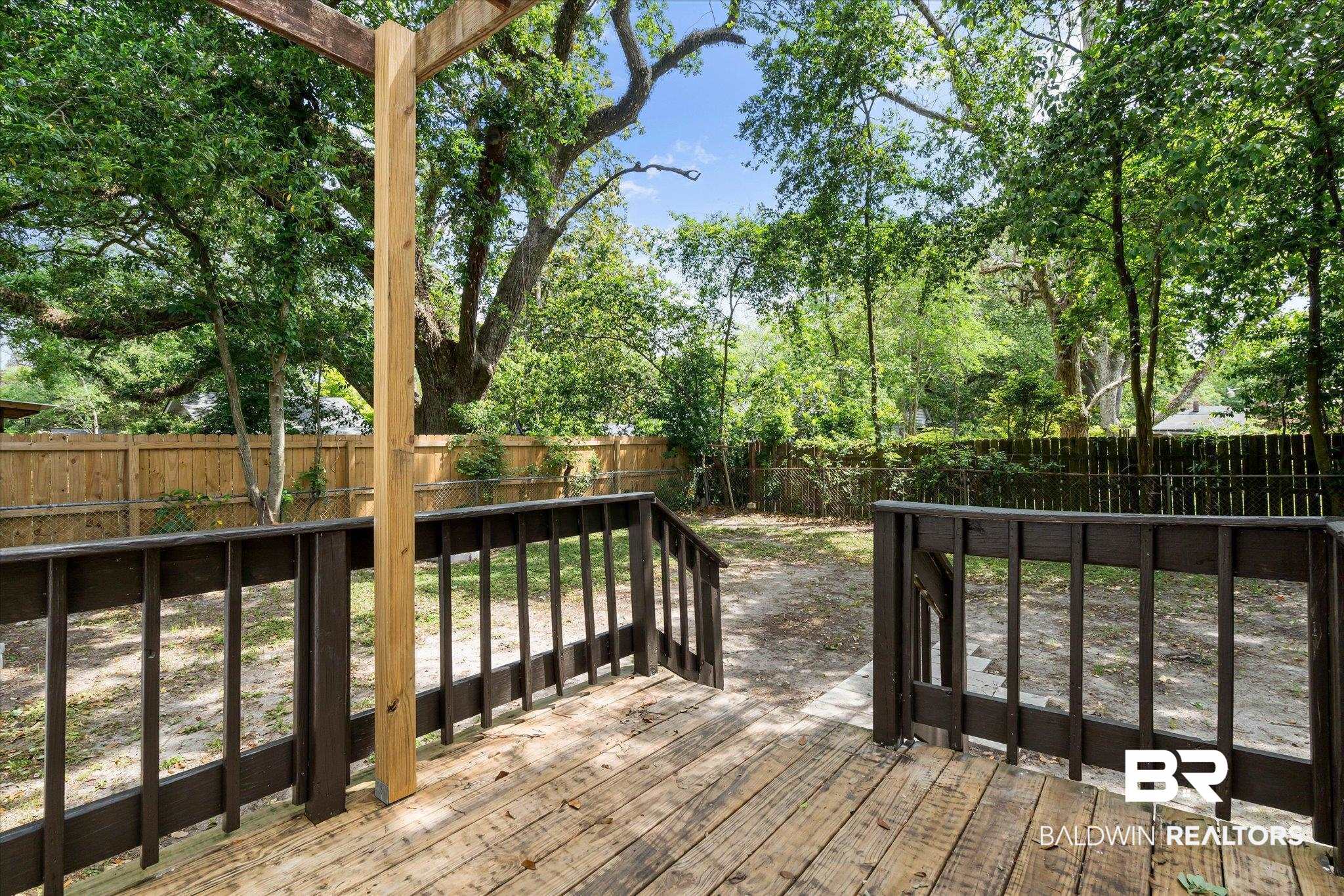 121 Westwood Street Mobile, AL 36606 - Photo 16 of 20 Wooden terrace with a fenced backyard