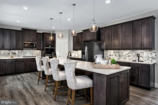 a kitchen with granite countertop a sink appliances and cabinets