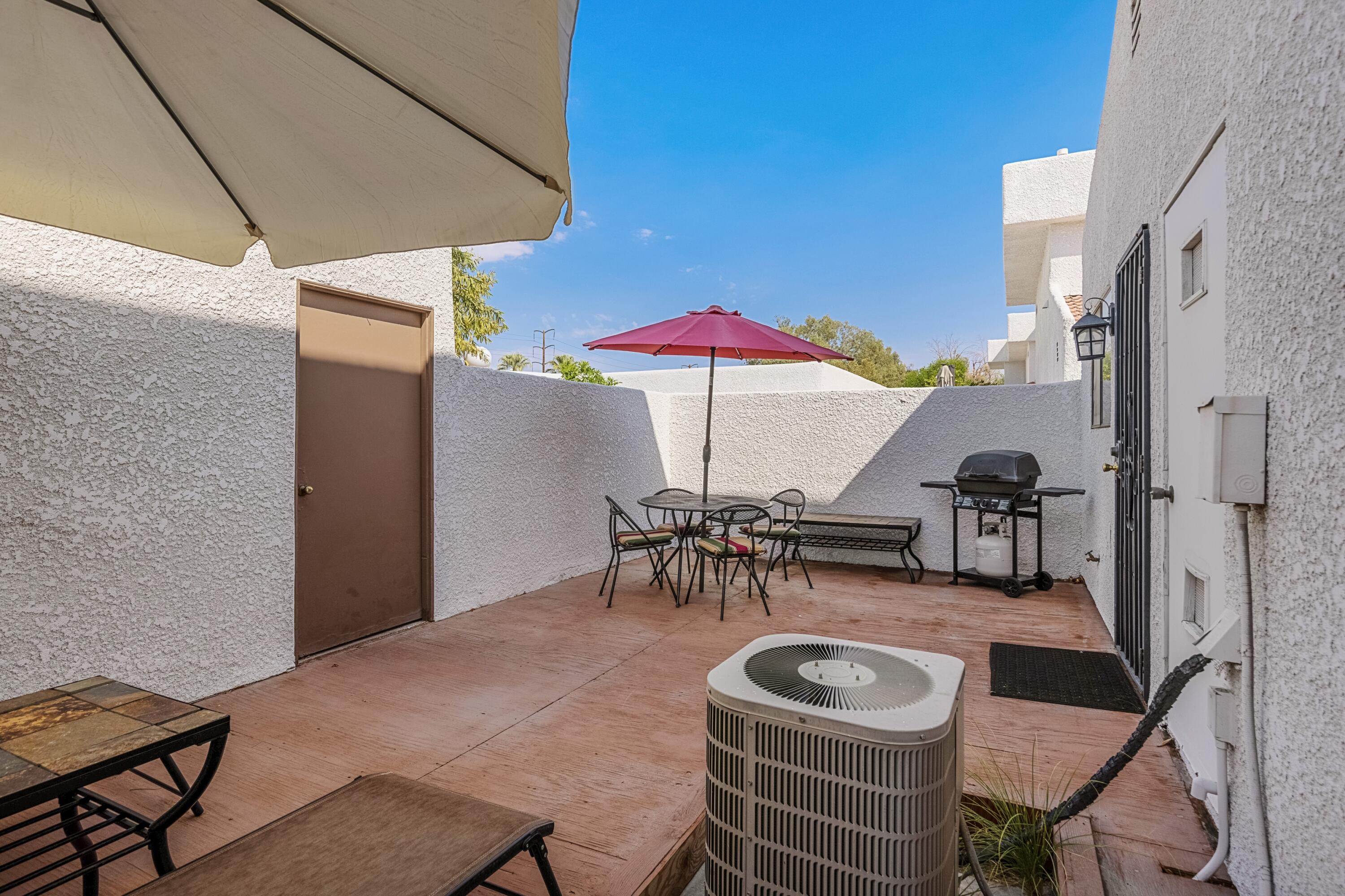 34352 Laura Way Rancho Mirage, CA 92270 - Photo 12 of 36 a view of a patio with chairs and umbrellas under an umbrella