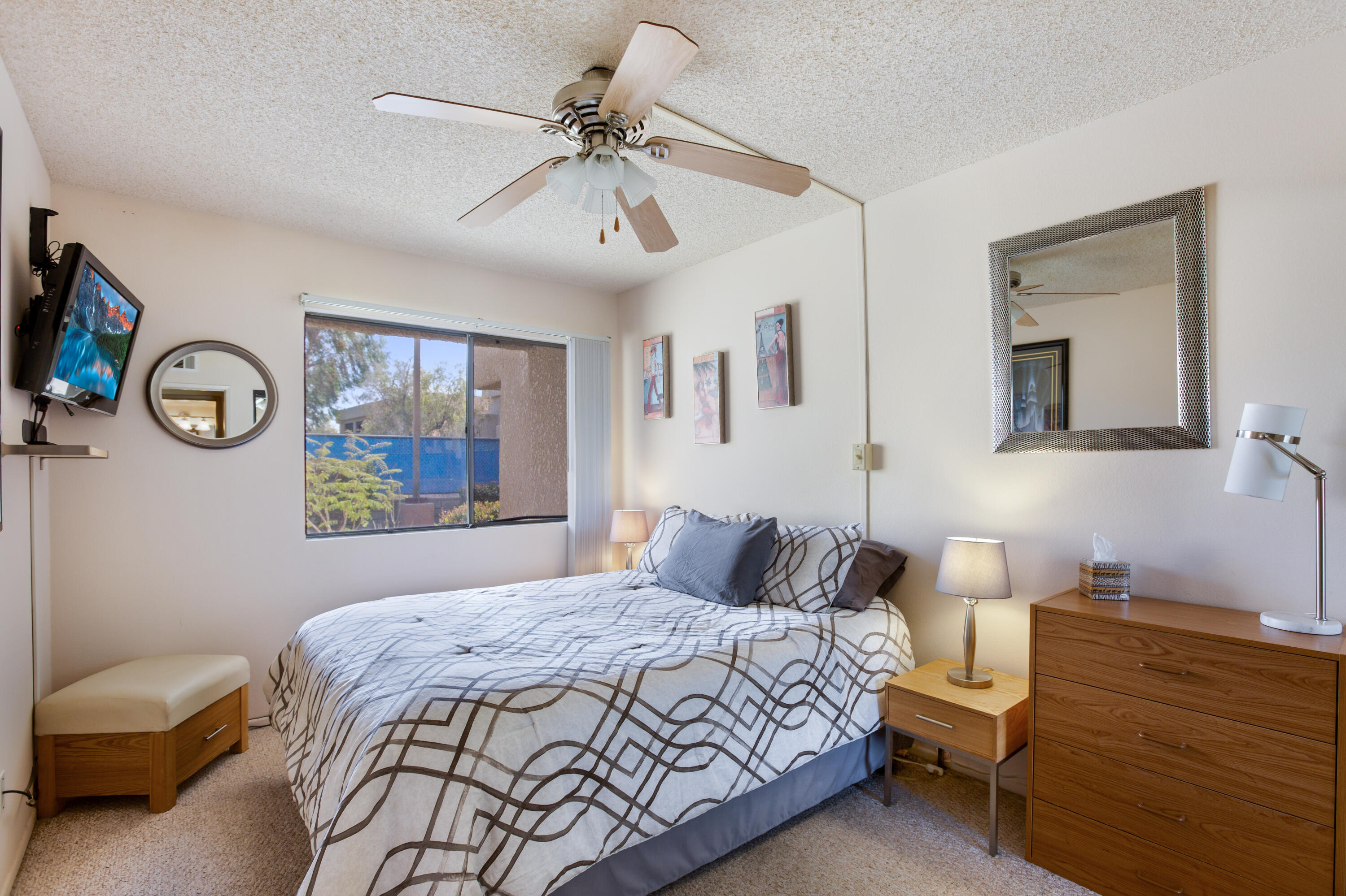 34352 Laura Way Rancho Mirage, CA 92270 - Photo 14 of 36 a bedroom with a bed and a chandelier