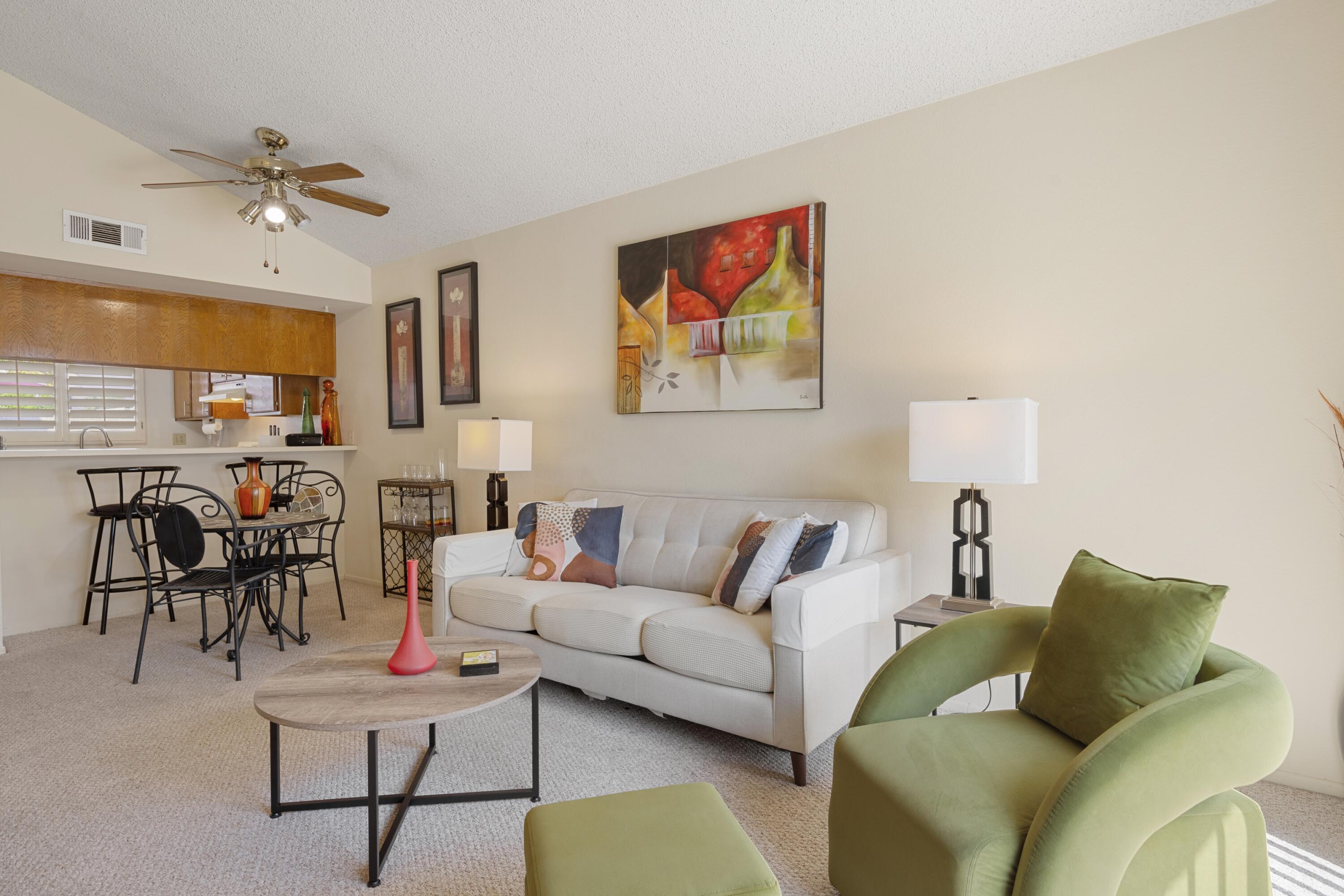 34352 Laura Way Rancho Mirage, CA 92270 - Photo 2 of 36 a living room with furniture and a chandelier