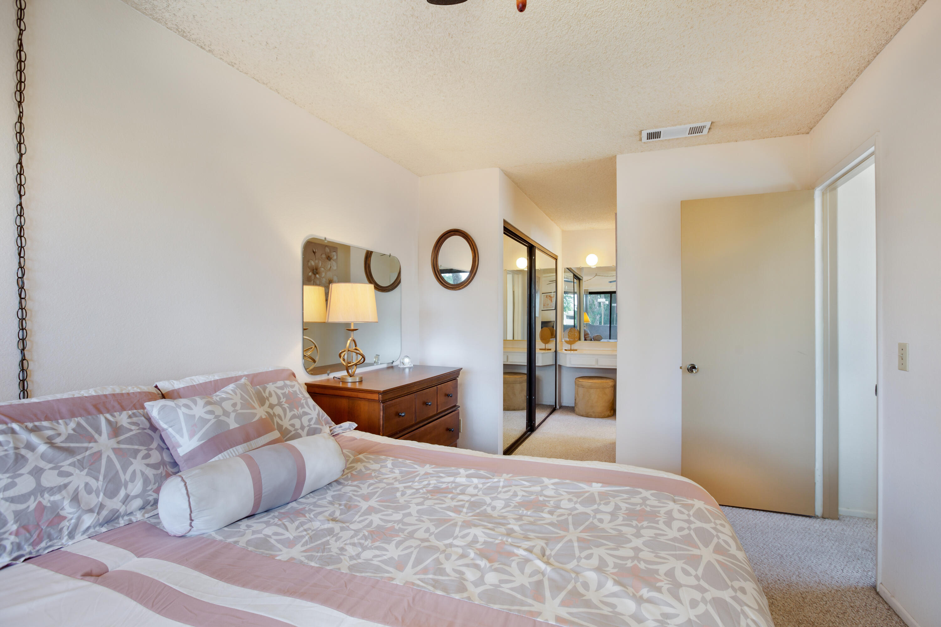 34352 Laura Way Rancho Mirage, CA 92270 - Photo 21 of 36 a bedroom with a large bed and a dresser
