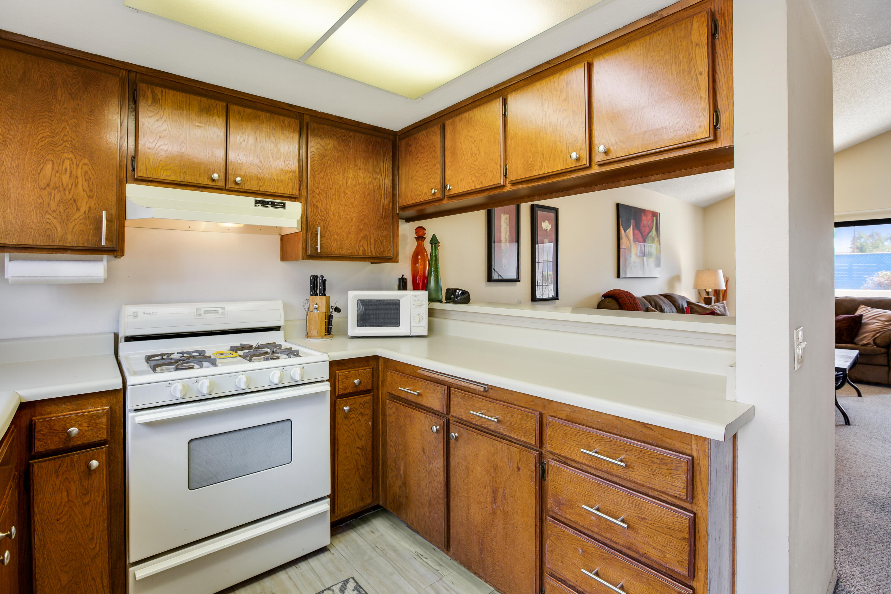34352 Laura Way Rancho Mirage, CA 92270 - Photo 7 of 36 a kitchen with cabinets and a stove top oven