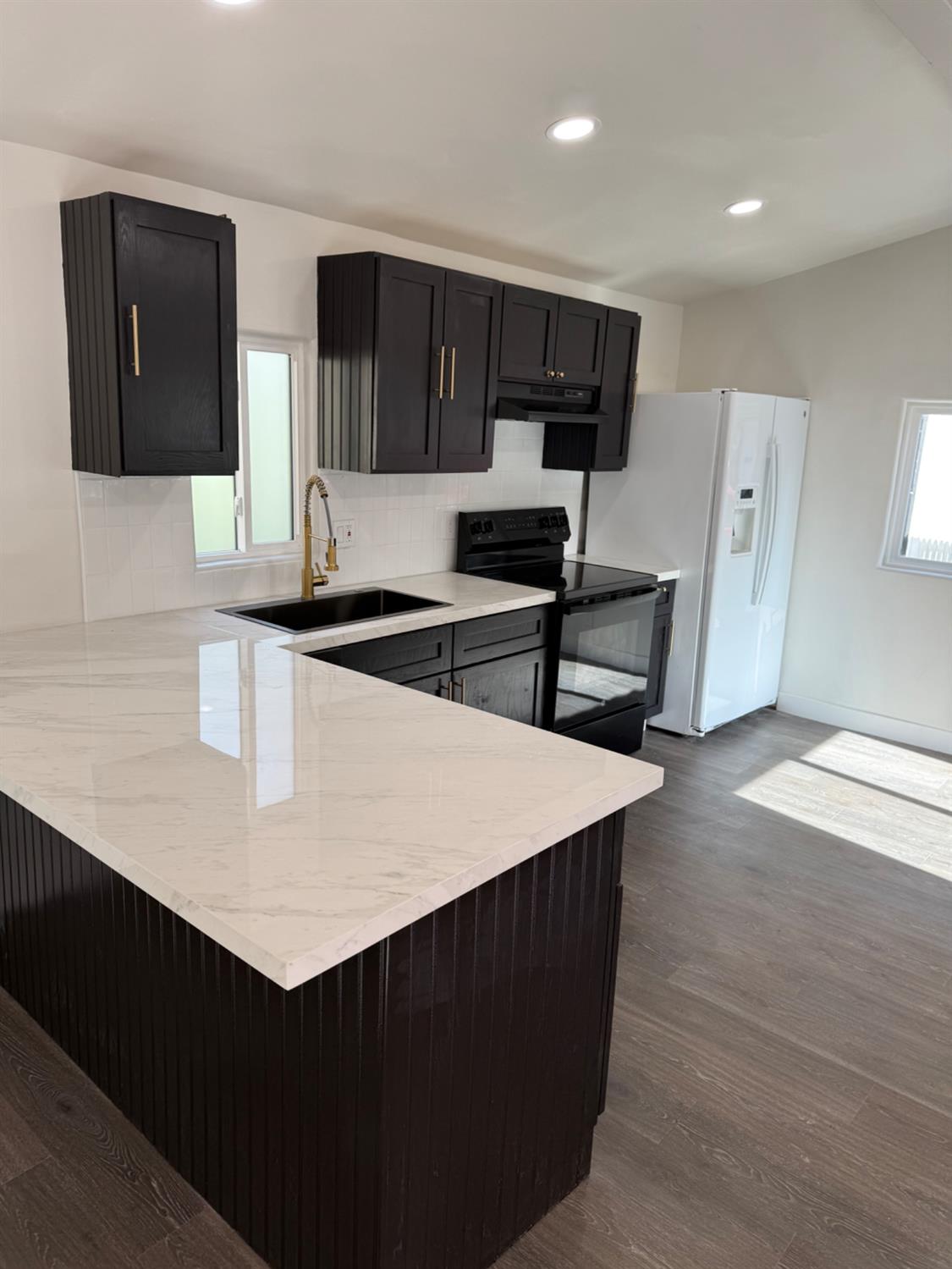 6060 Pony Express Trail, Unit 18 Pollock Pines, CA 95726 - Photo 10 of 17 a kitchen with stainless steel appliances a stove a sink a microwave and wooden cabinets