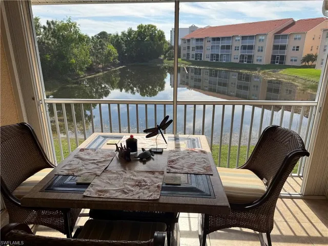 a view of a balcony with lake view and wooden floor