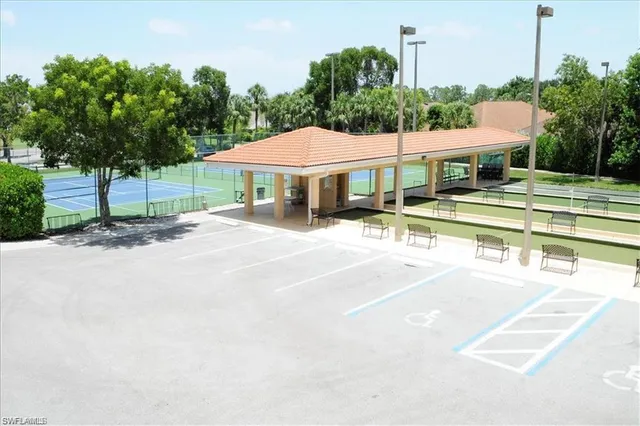 a patio with a table and chairs under an umbrella