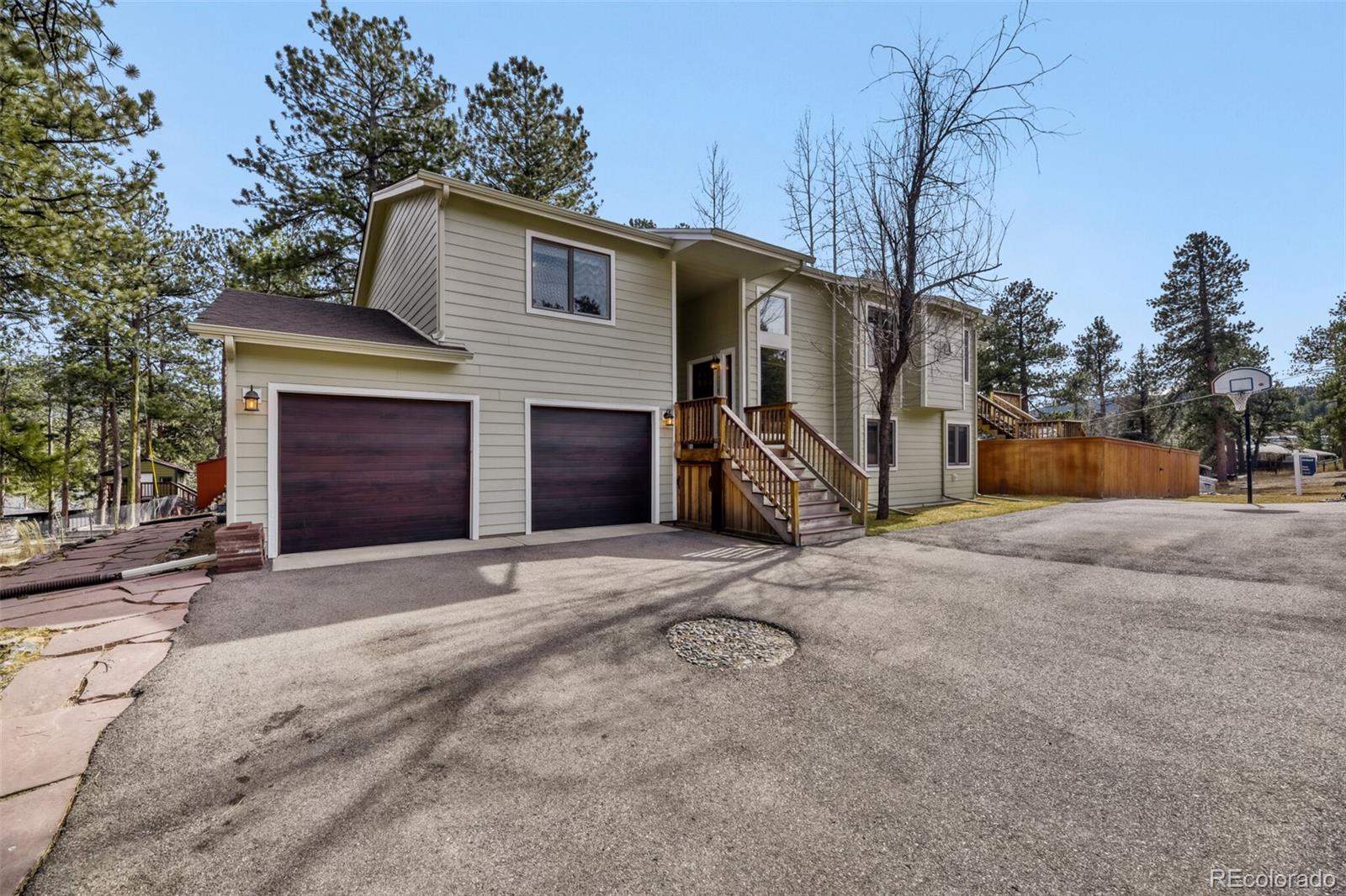 5000 Elizabeth Lane Evergreen, CO 80439 - Photo 1 of 30 a front view of a house with a yard and garage