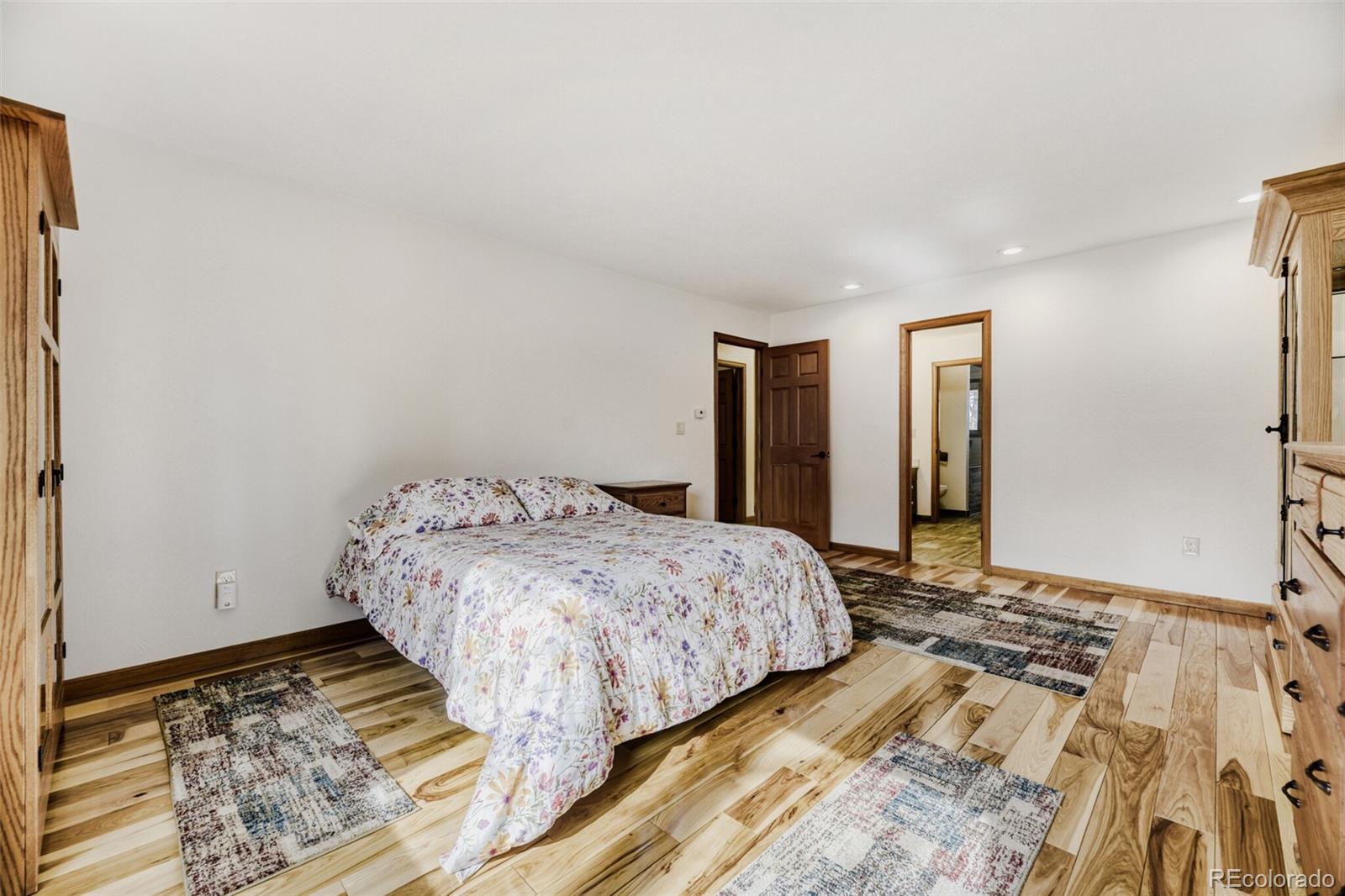 5000 Elizabeth Lane Evergreen, CO 80439 - Photo 12 of 30 a bedroom with a bed and wooden floor