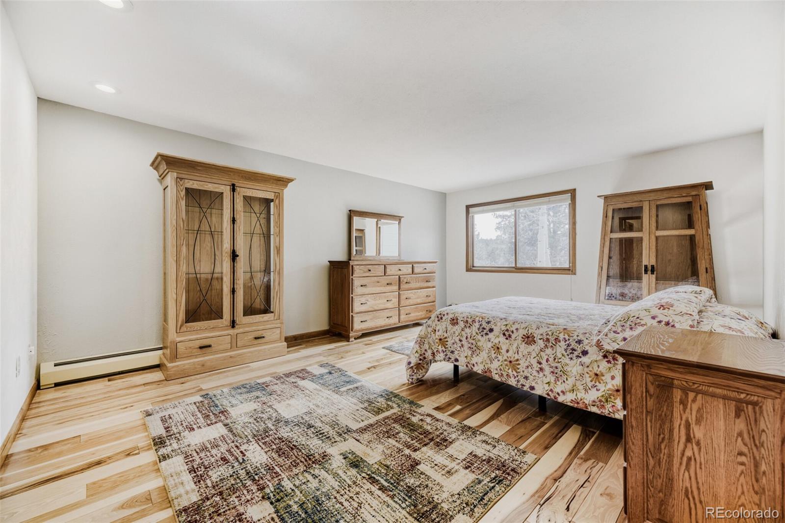 5000 Elizabeth Lane Evergreen, CO 80439 - Photo 13 of 30 a bedroom with a large bed and dresser