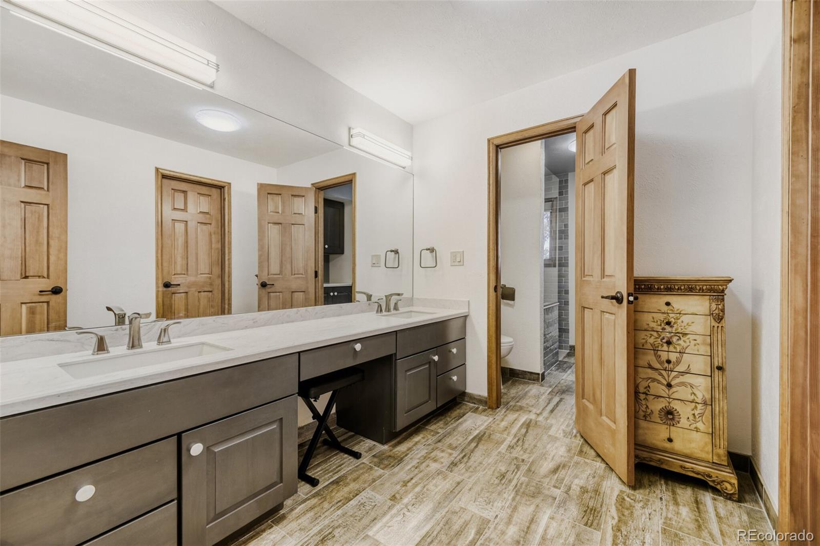 5000 Elizabeth Lane Evergreen, CO 80439 - Photo 14 of 30 a spacious bathroom with a double vanity sink double and a mirror