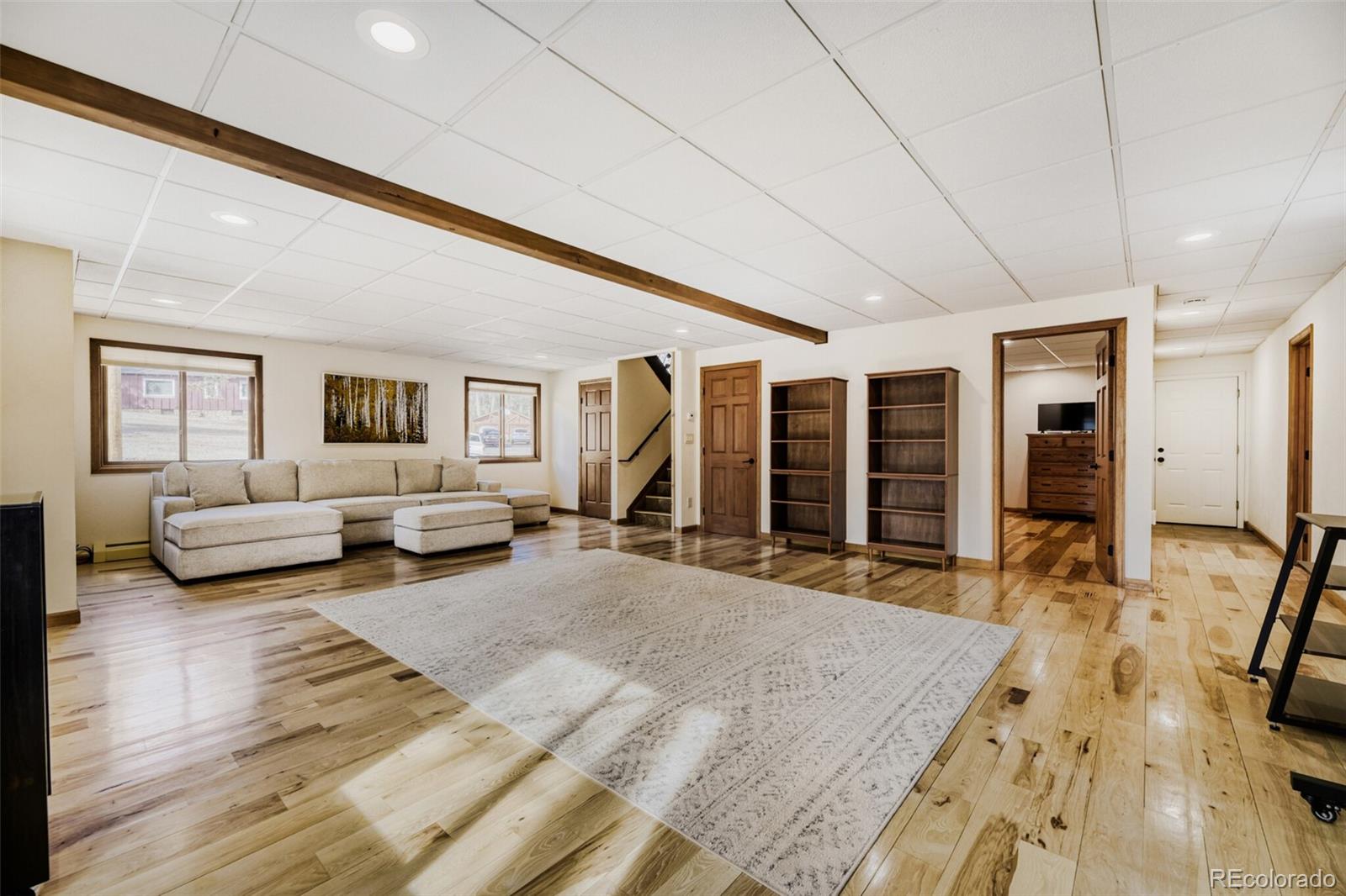 5000 Elizabeth Lane Evergreen, CO 80439 - Photo 20 of 30 a spacious bedroom with a bed a couch and large window