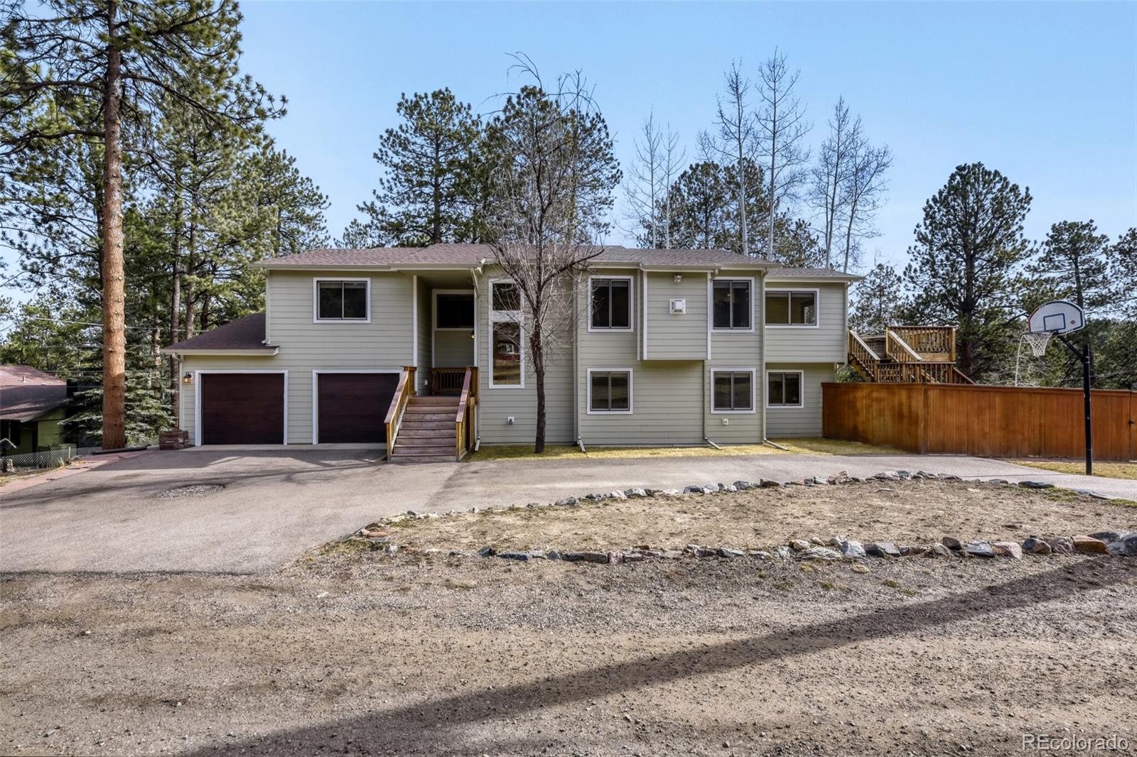 5000 Elizabeth Lane Evergreen, CO 80439 - Photo 2 of 30 a front view of a house with a yard and garage