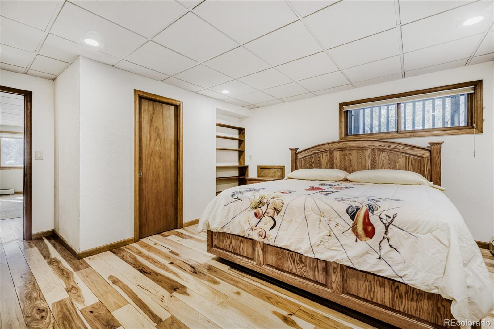 5000 Elizabeth Lane Evergreen, CO 80439 - Photo 23 of 30 a bedroom with a large bed and a window