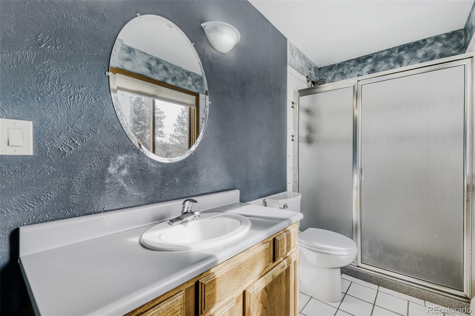 5000 Elizabeth Lane Evergreen, CO 80439 - Photo 24 of 30 a bathroom with a sink and a mirror