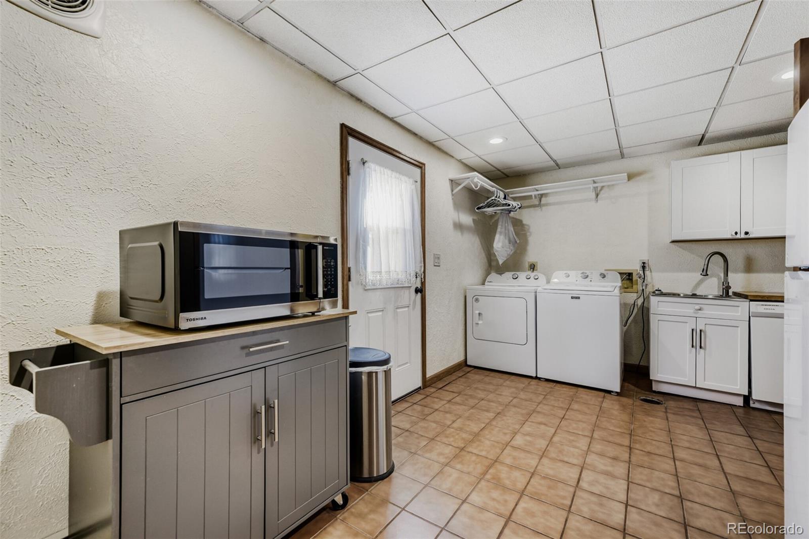 5000 Elizabeth Lane Evergreen, CO 80439 - Photo 25 of 30 a utility room with cabinets washer and dryer