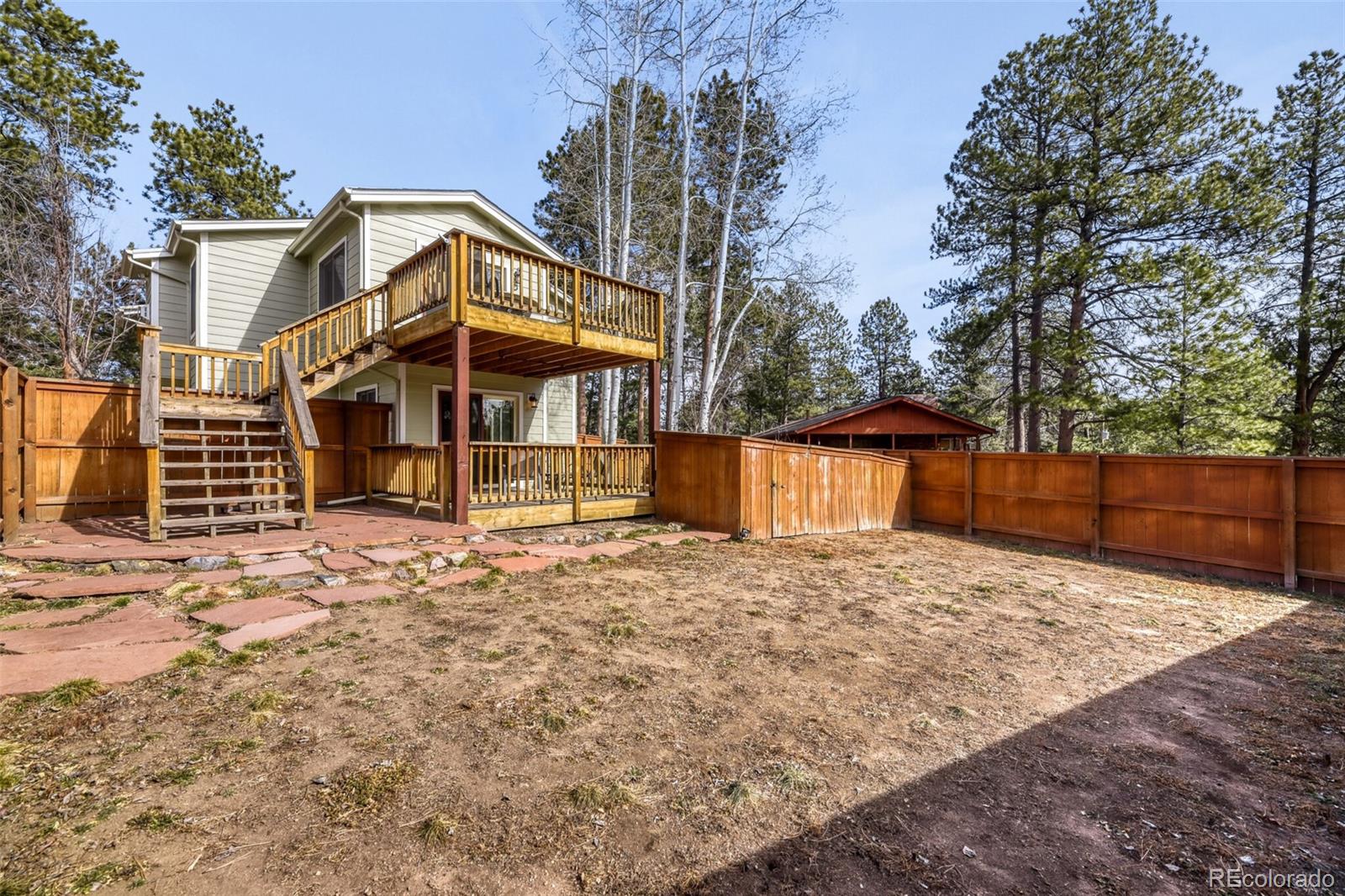 5000 Elizabeth Lane Evergreen, CO 80439 - Photo 27 of 30 a front view of a house with a yard covered with snow in the background