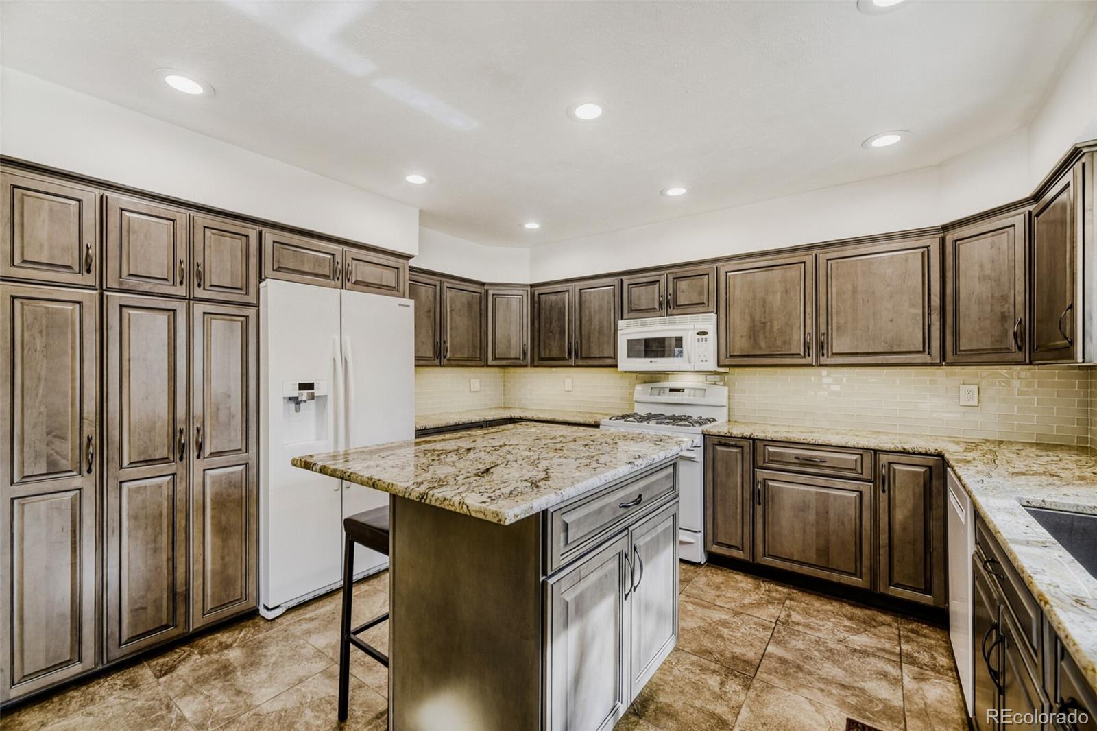 5000 Elizabeth Lane Evergreen, CO 80439 - Photo 8 of 30 a kitchen with stainless steel appliances granite countertop a refrigerator sink and cabinets