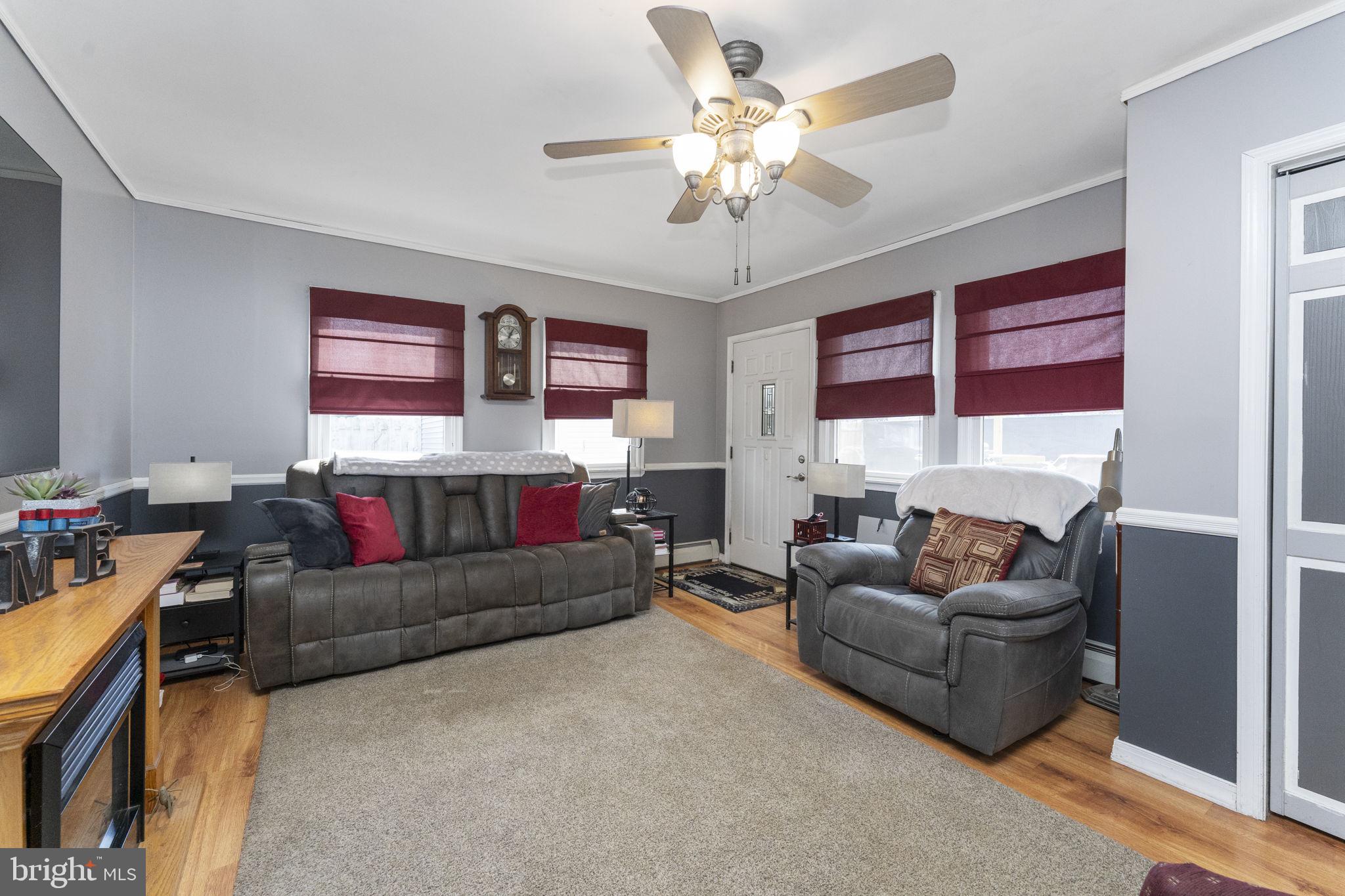 60 Inland Road Levittown, PA 19057 - Photo 16 of 32 a living room with furniture and a chandelier