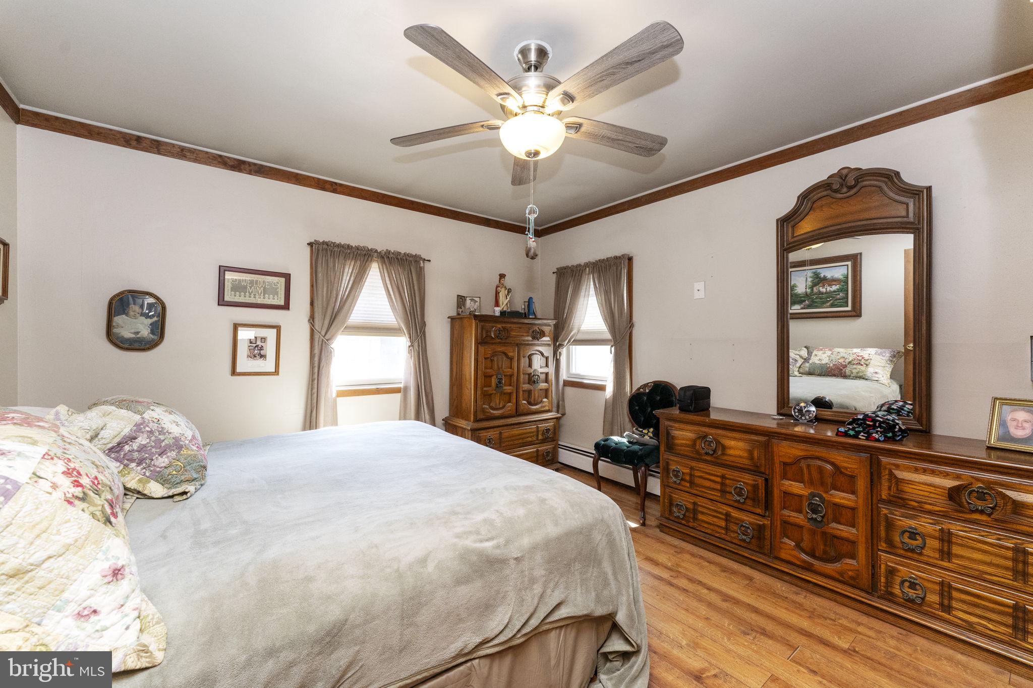 60 Inland Road Levittown, PA 19057 - Photo 21 of 32 a bedroom with a bed dresser and wooden floor