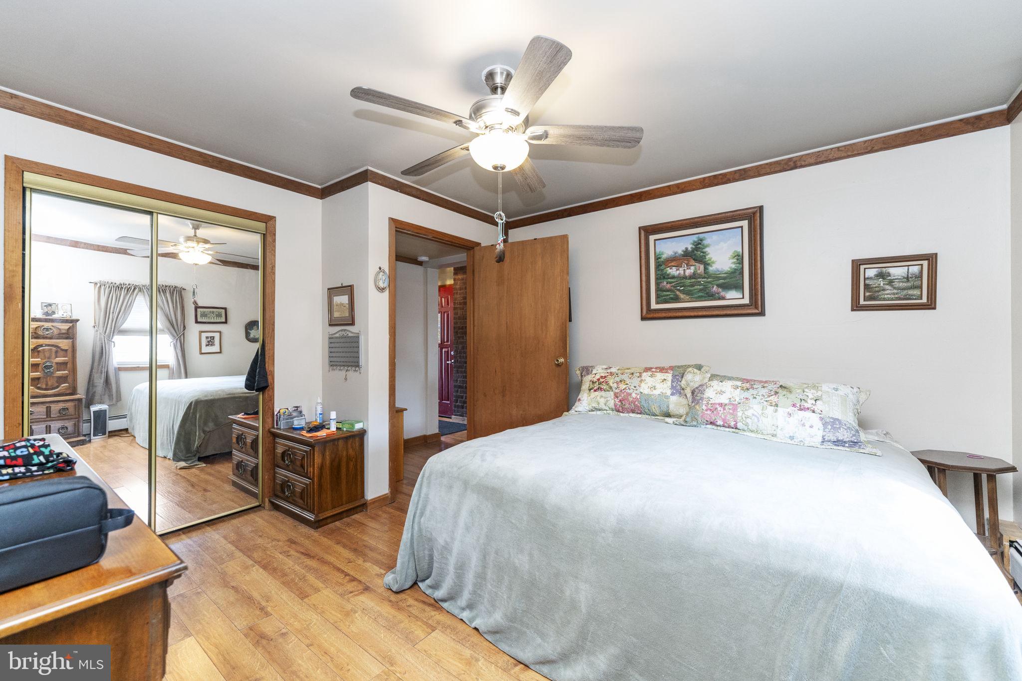 60 Inland Road Levittown, PA 19057 - Photo 22 of 32 a bedroom with a large bed and a chandelier