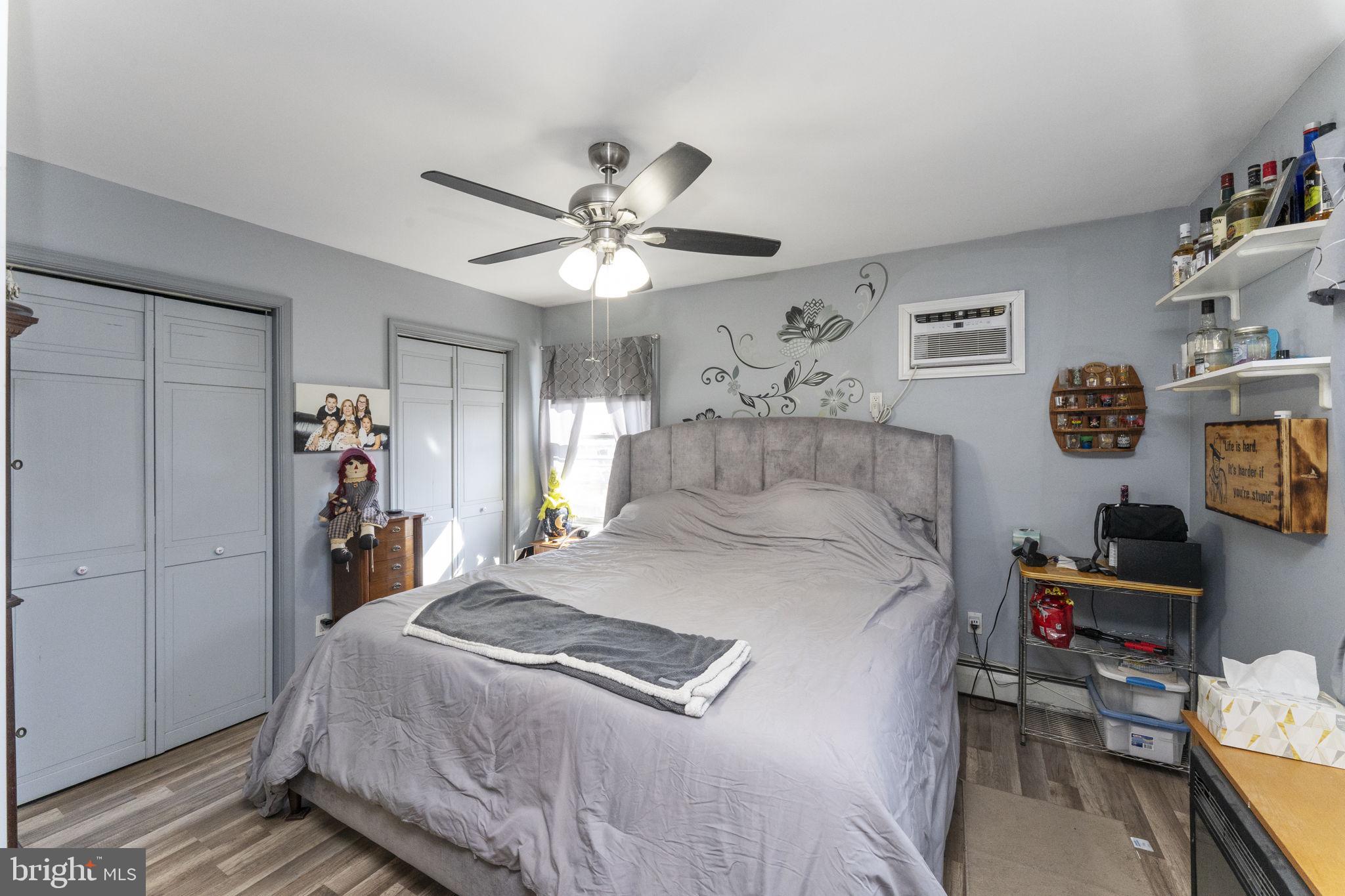60 Inland Road Levittown, PA 19057 - Photo 31 of 32 a bedroom with a bed and a chandelier