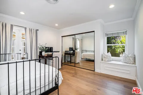 a bedroom with furniture and a window