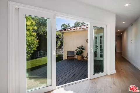 a view of a entryway door and hallway view