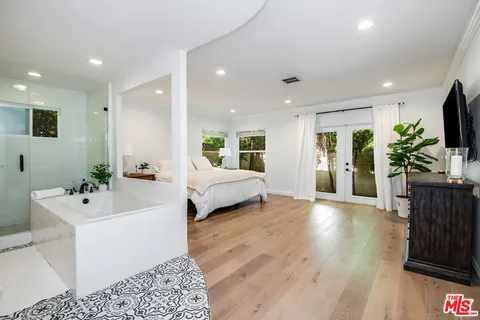 a spacious bedroom with a large bed and a couch