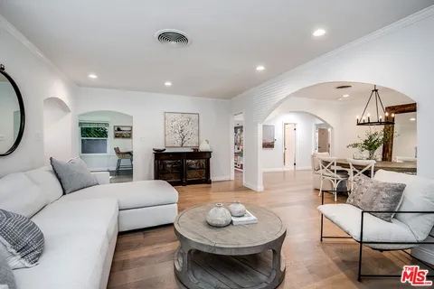a living room with furniture and a mirror