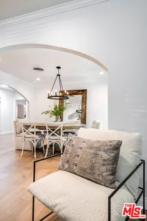 a living room with furniture a rug and white walls