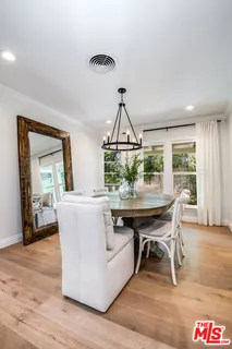 a living room with a table and chairs