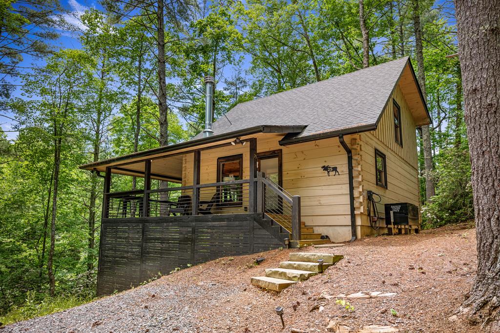 a backyard of a house with barbeque oven and outdoor seating