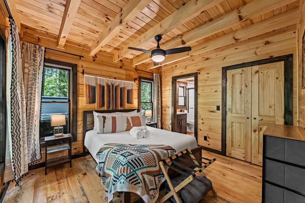 25 Hidden Ridge Cherry Log, GA 30522 - Photo 35 of 52 a bed room with a bed and wooden floor