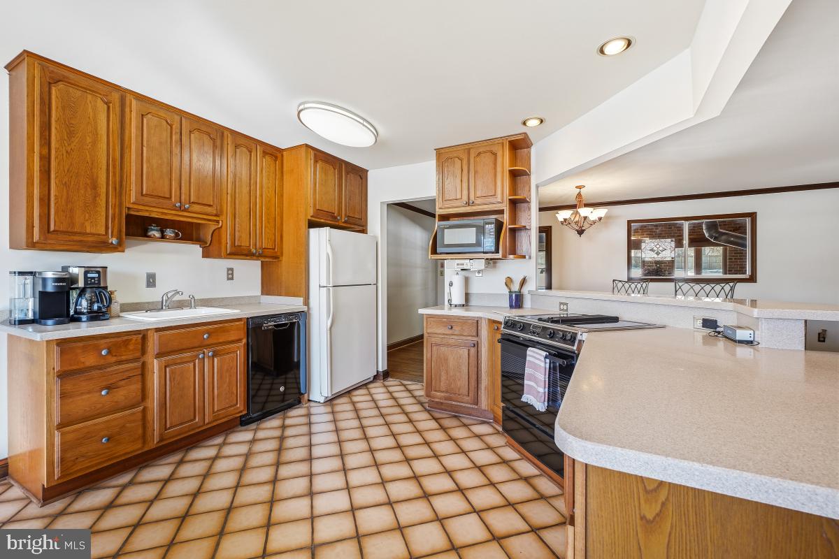24357 Flamingo Terrace Gaithersburg, MD 20882 - Photo 13 of 41 a kitchen with a sink appliances and cabinets