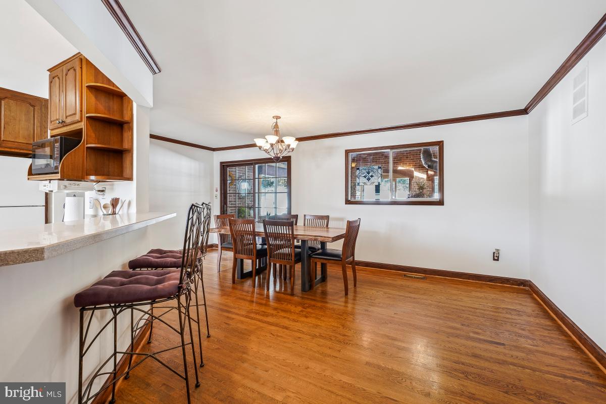 24357 Flamingo Terrace Gaithersburg, MD 20882 - Photo 17 of 41 a view of a dining room with furniture and chandelier