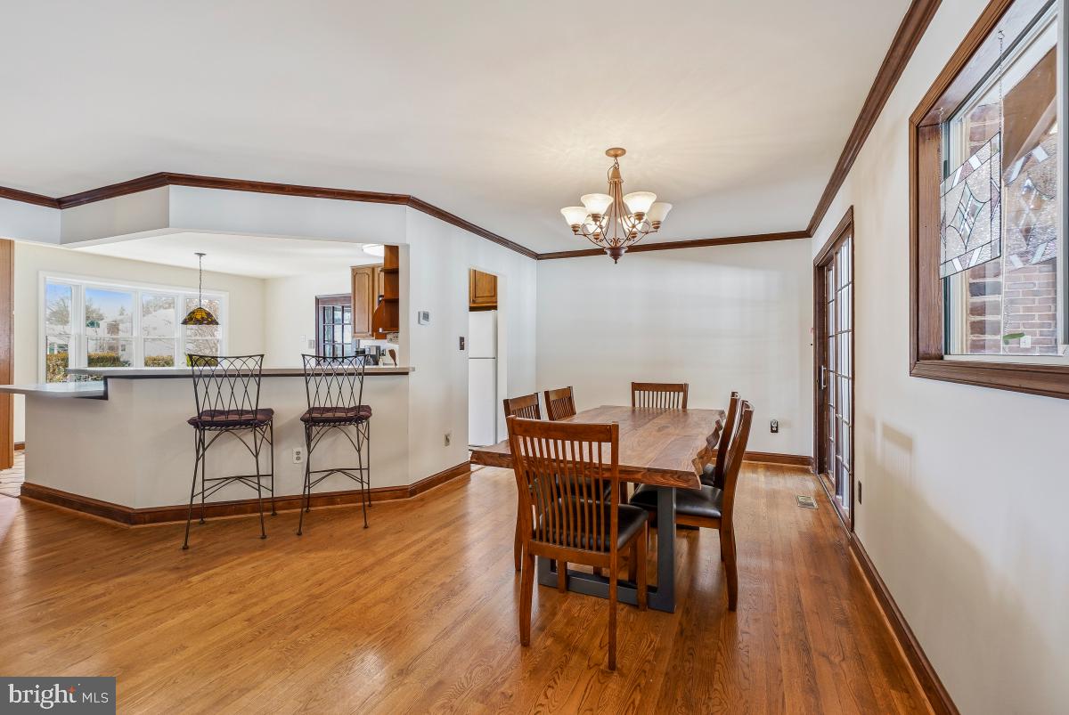 24357 Flamingo Terrace Gaithersburg, MD 20882 - Photo 18 of 41 a view of a dining room with furniture and wooden floor