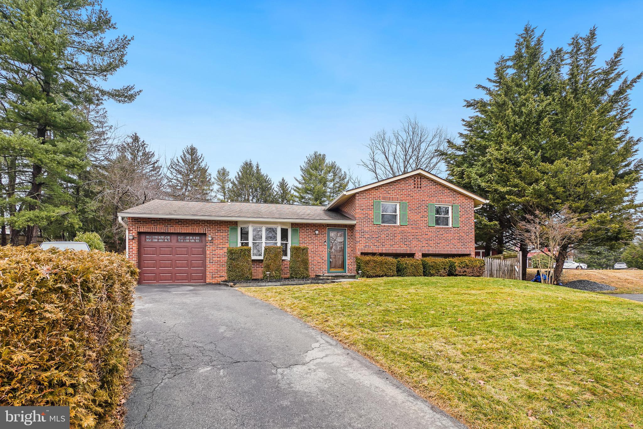 24357 Flamingo Terrace Gaithersburg, MD 20882 - Photo 2 of 41 a front view of a house with a yard and trees