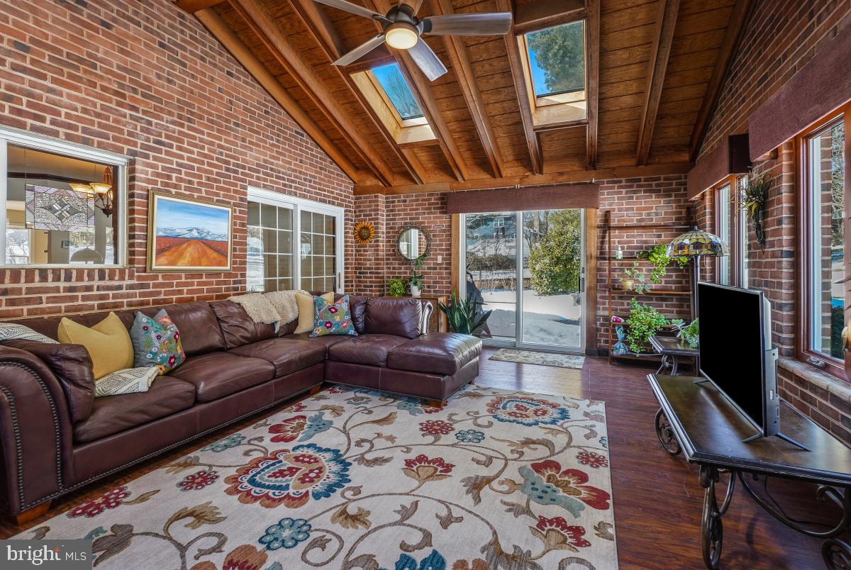 24357 Flamingo Terrace Gaithersburg, MD 20882 - Photo 23 of 41 a living room with furniture a fireplace and a flat screen tv