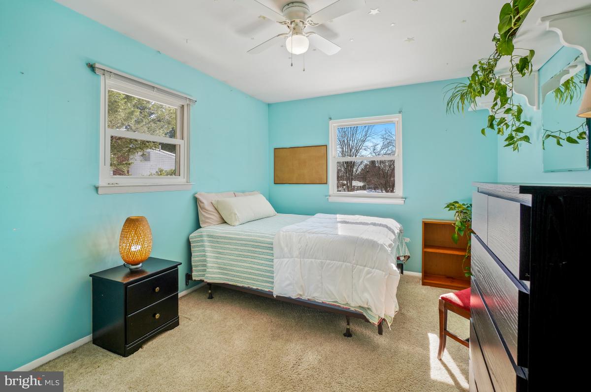 24357 Flamingo Terrace Gaithersburg, MD 20882 - Photo 29 of 41 a bedroom with a bed and a chandelier