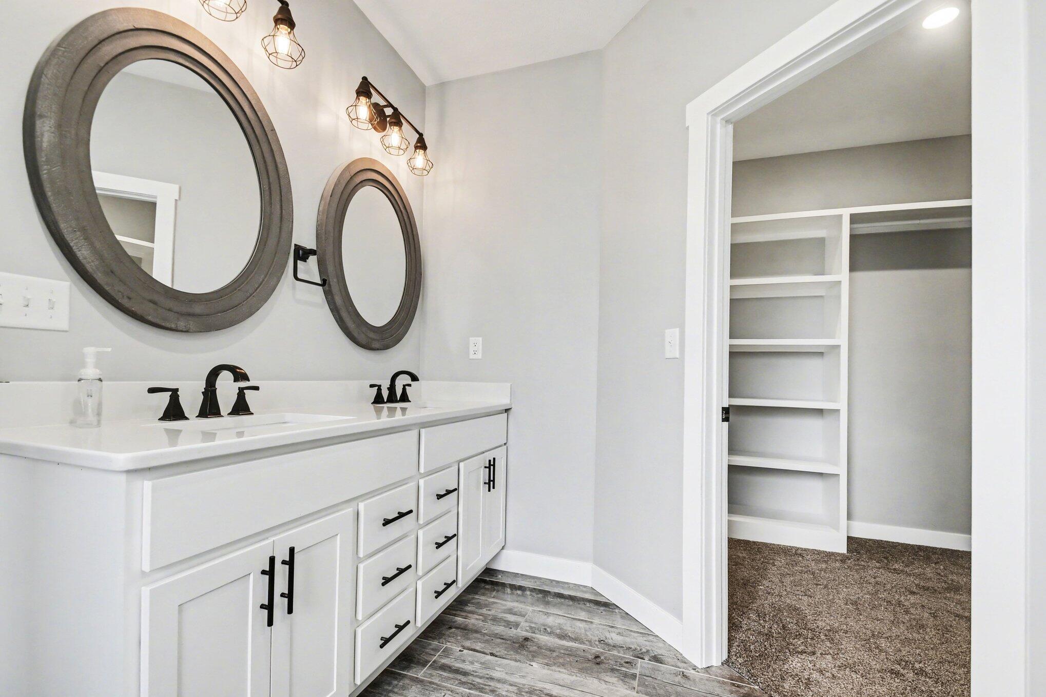 20009 Weber Lane Goshen, IN 46528 - Photo 17 of 17 a bathroom with a granite countertop sink a mirror and a vanity
