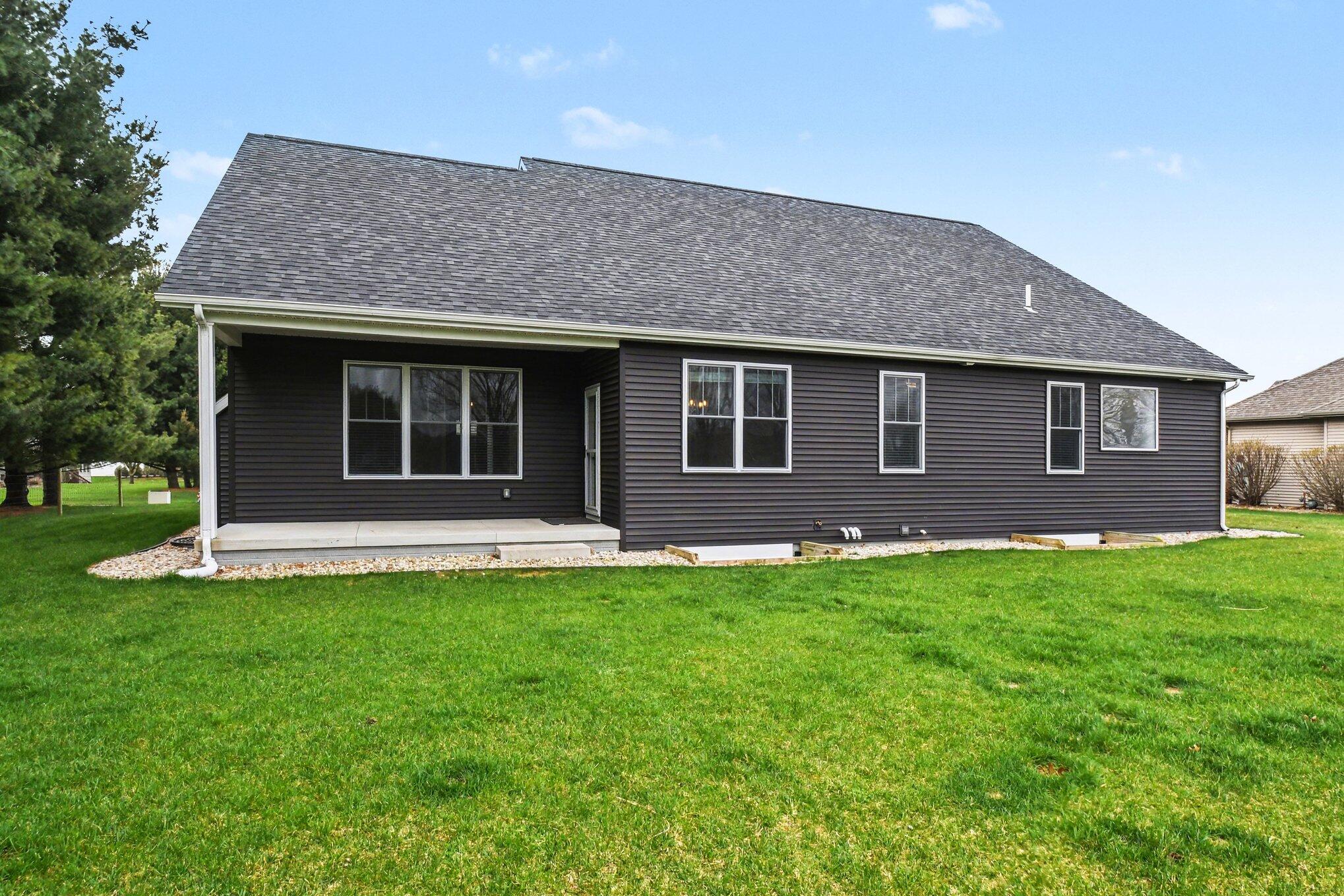20009 Weber Lane Goshen, IN 46528 - Photo 2 of 17 a front view of a house with a garden