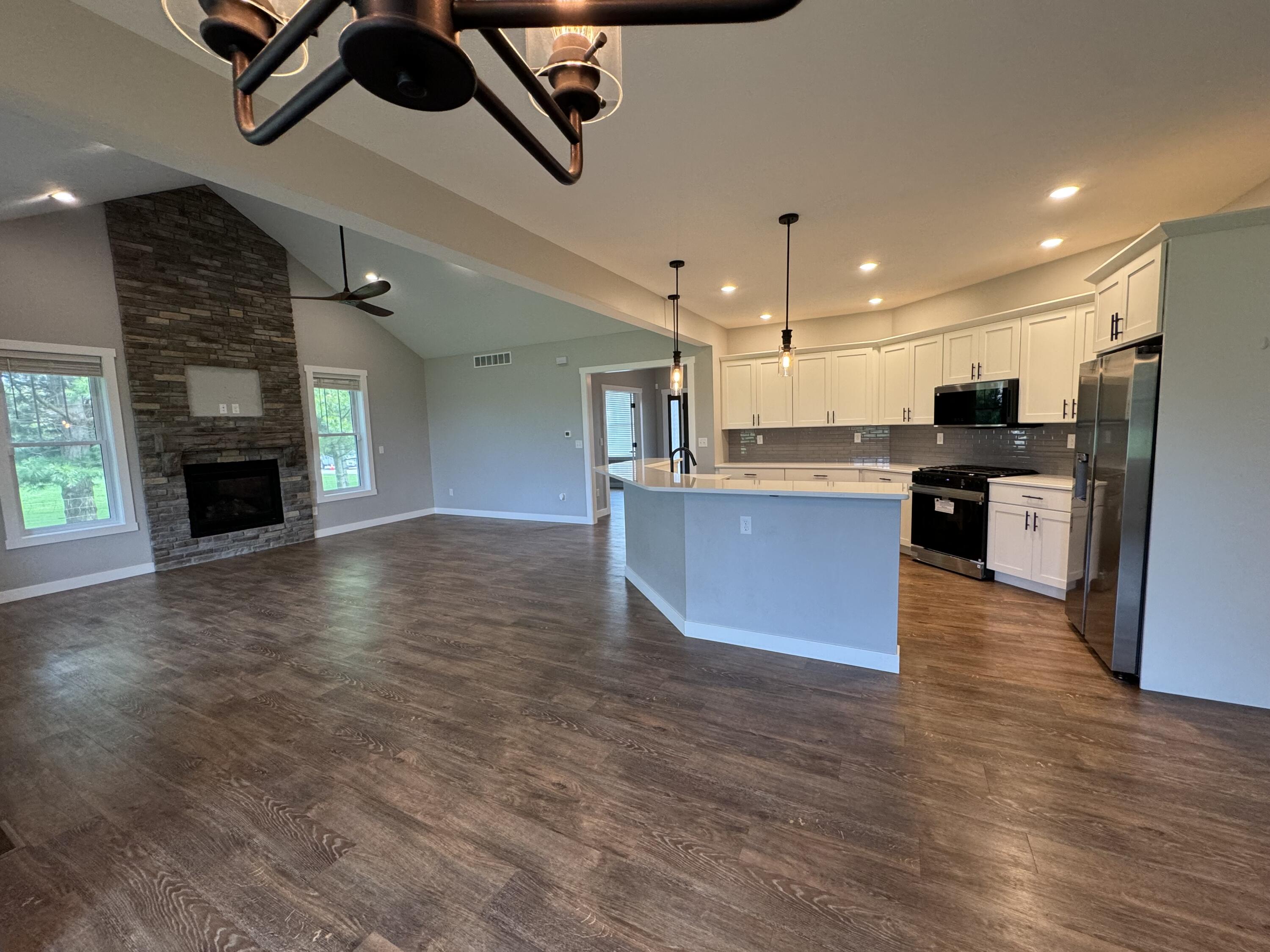 20009 Weber Lane Goshen, IN 46528 - Photo 3 of 17 a large kitchen with cabinets wooden floor and stainless steel appliances