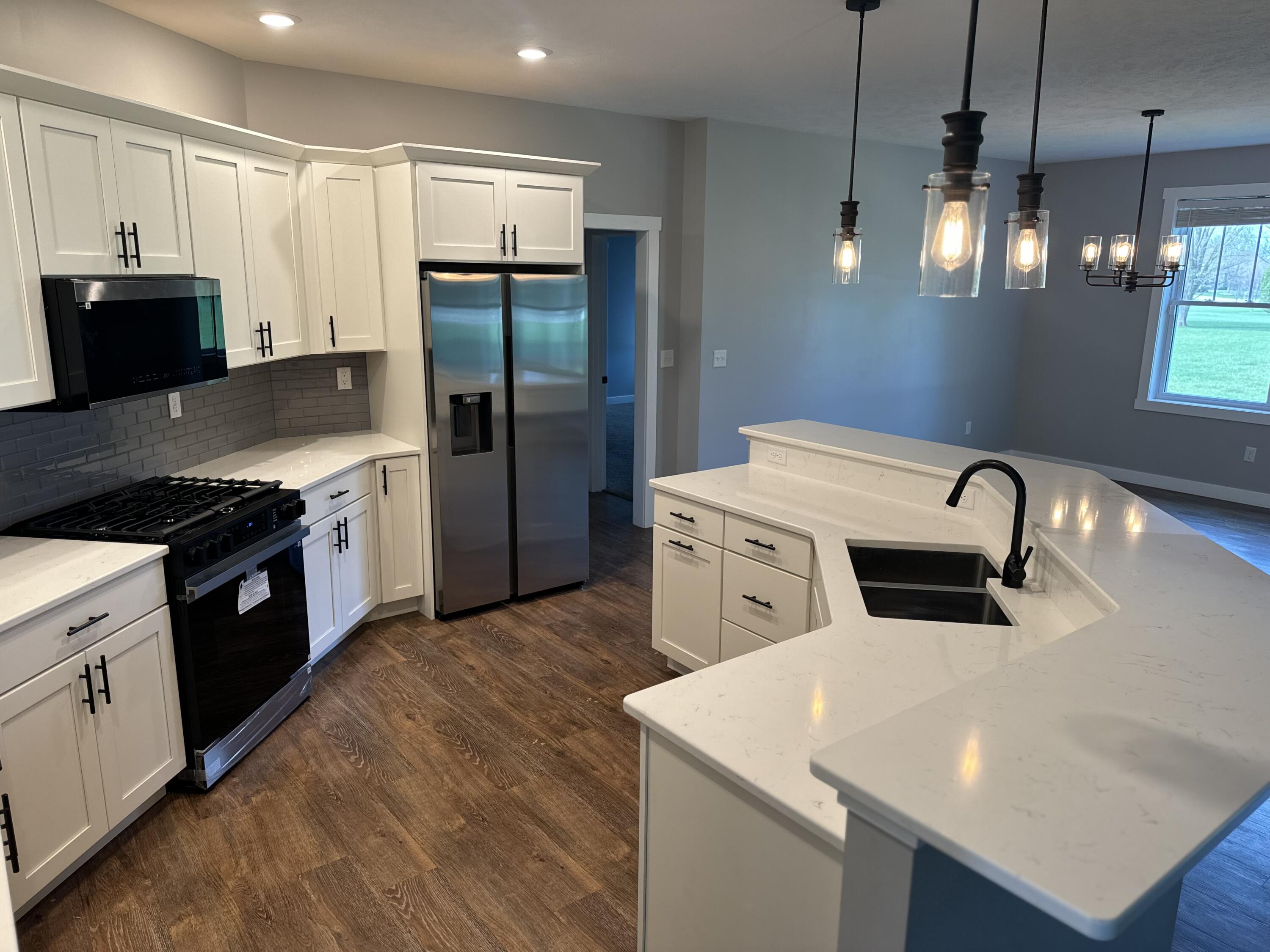 20009 Weber Lane Goshen, IN 46528 - Photo 4 of 17 a kitchen that has a sink a stove and stainless steel appliances