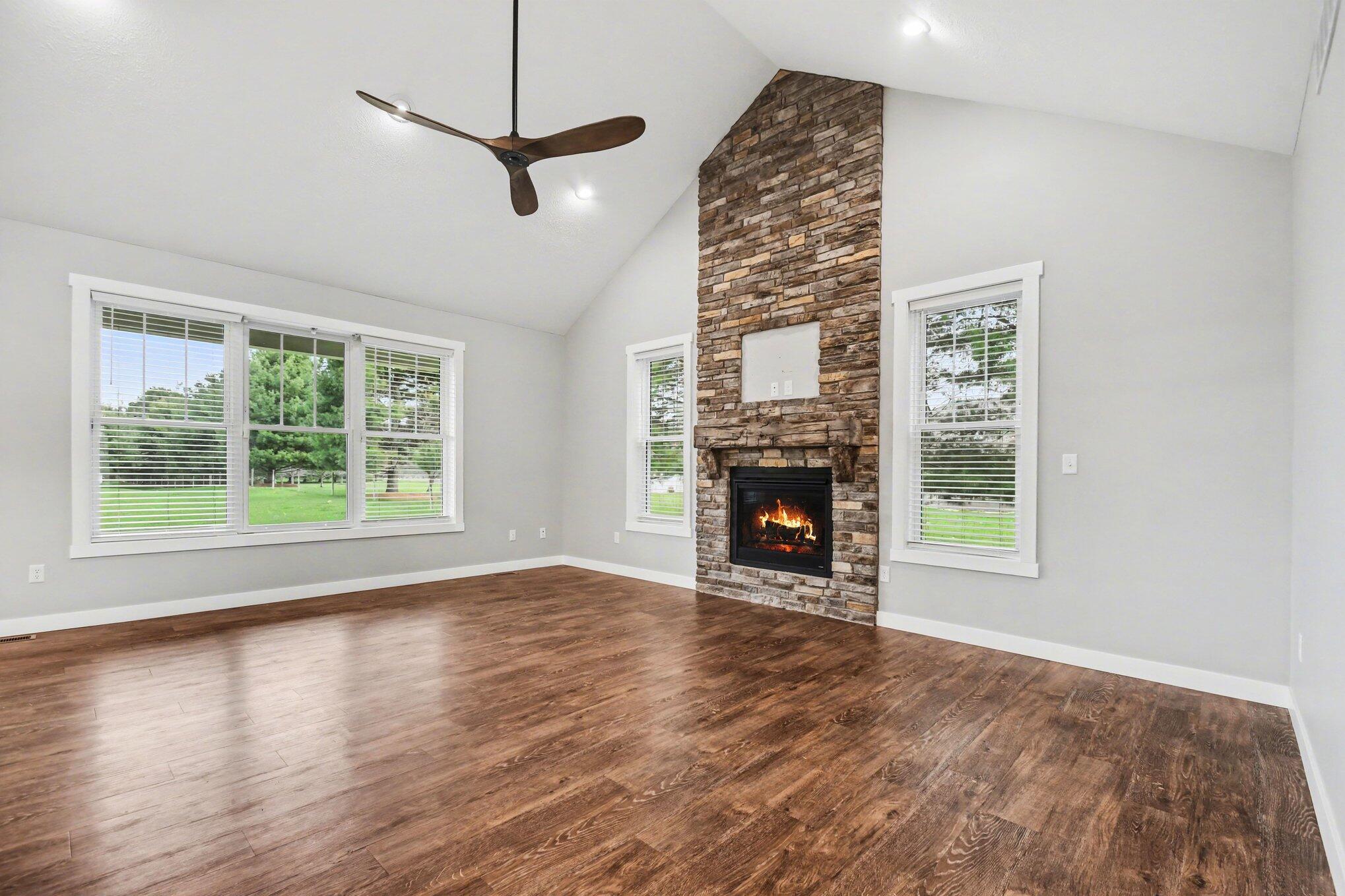 20009 Weber Lane Goshen, IN 46528 - Photo 7 of 17 a view of an empty room with wooden floor fireplace and a window