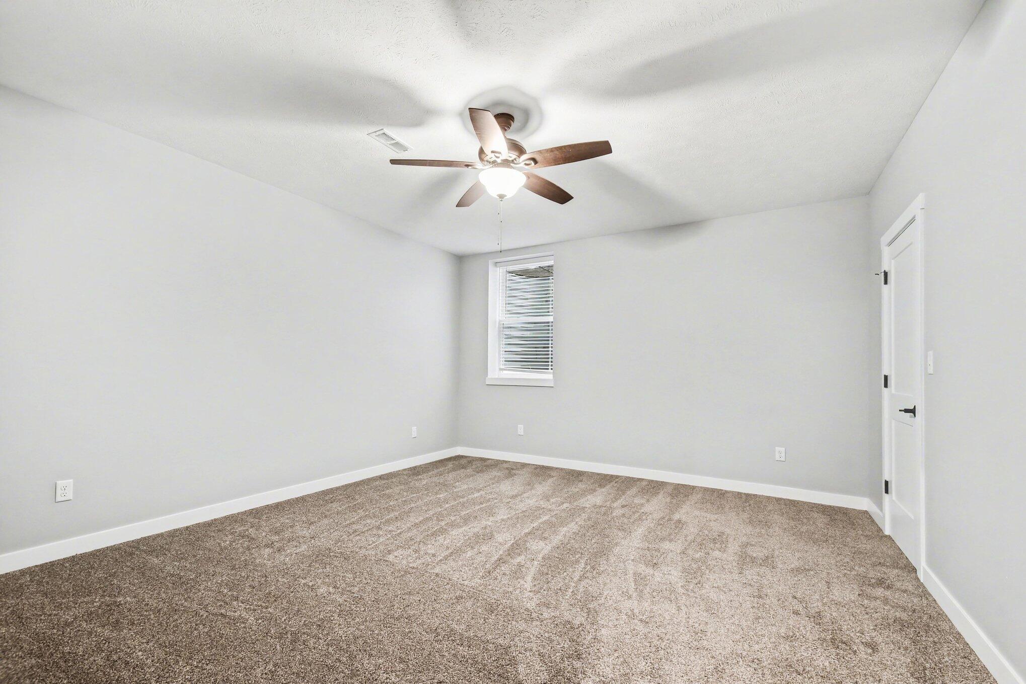 20009 Weber Lane Goshen, IN 46528 - Photo 9 of 17 an empty room with windows and fan