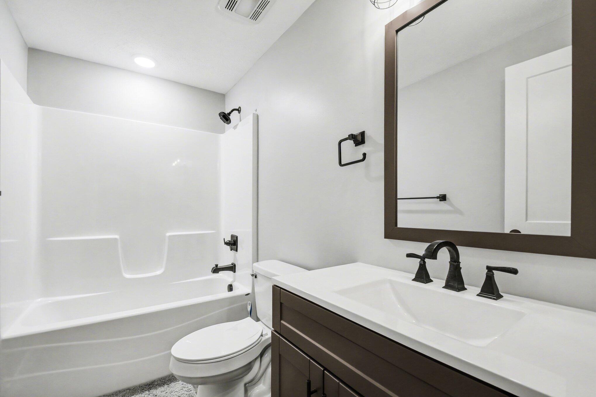 20009 Weber Lane Goshen, IN 46528 - Photo 10 of 17 a bathroom with a granite countertop sink toilet a mirror and shower