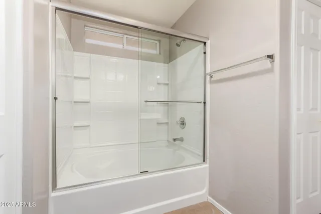 a view of walk in closet with clothes