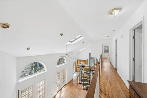 a view of a room with wooden floor and white walls